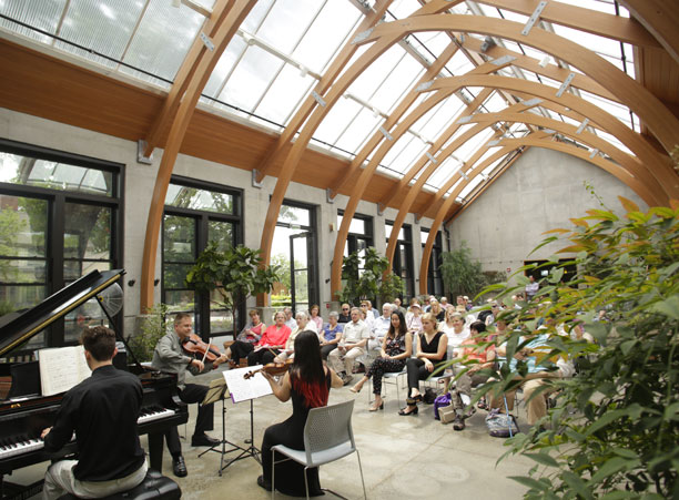 Participants of Holy Cross' Chamber Music Institute perform in a greenhouse at the Tower Hill Botanical Gardens